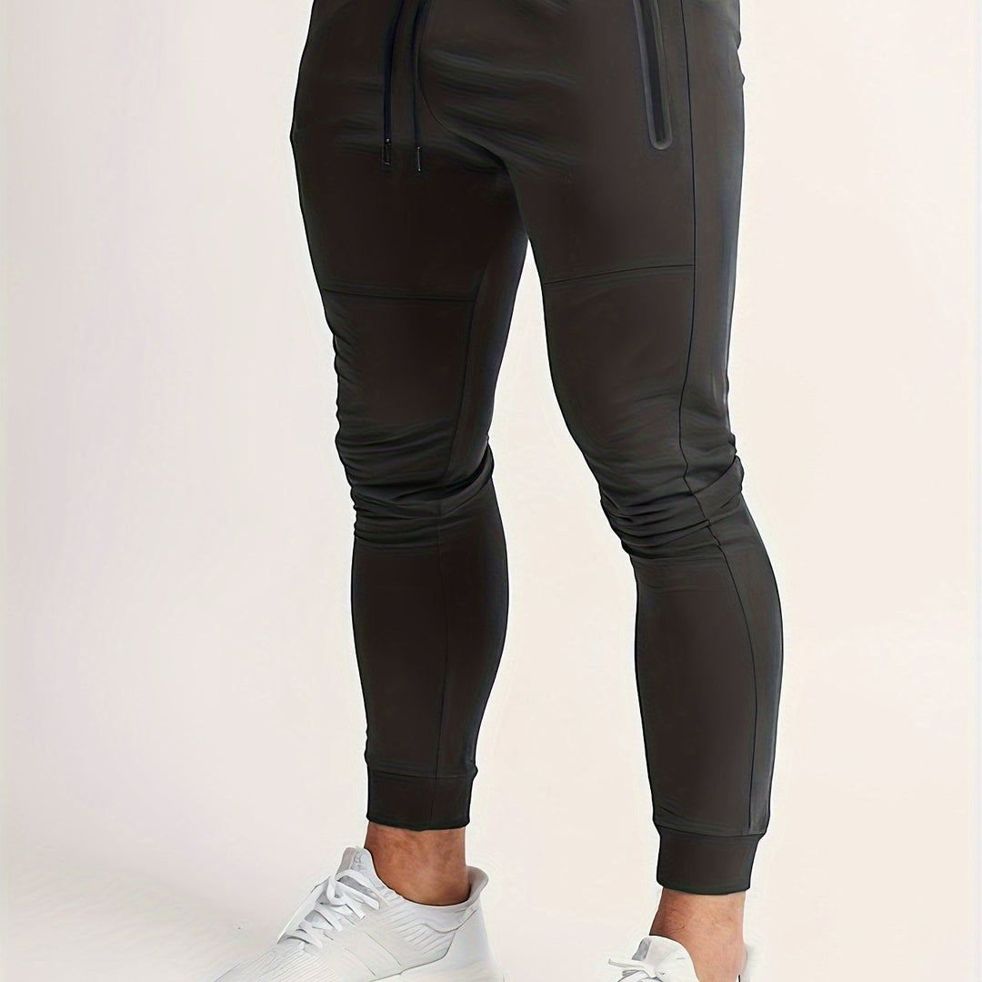 Light gray men's slim fit performance joggers, comfortable activewear. New polyester pants.