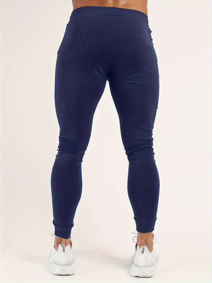 New black slim fit joggers, polyester blend for active men. Perfect for athletic and casual wear.