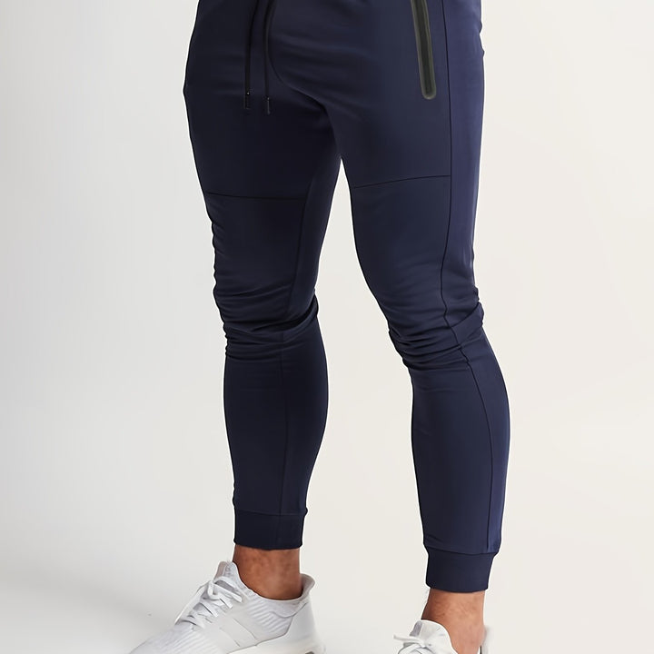 Light gray men's performance joggers, slim fit and comfortable. New activewear for men.