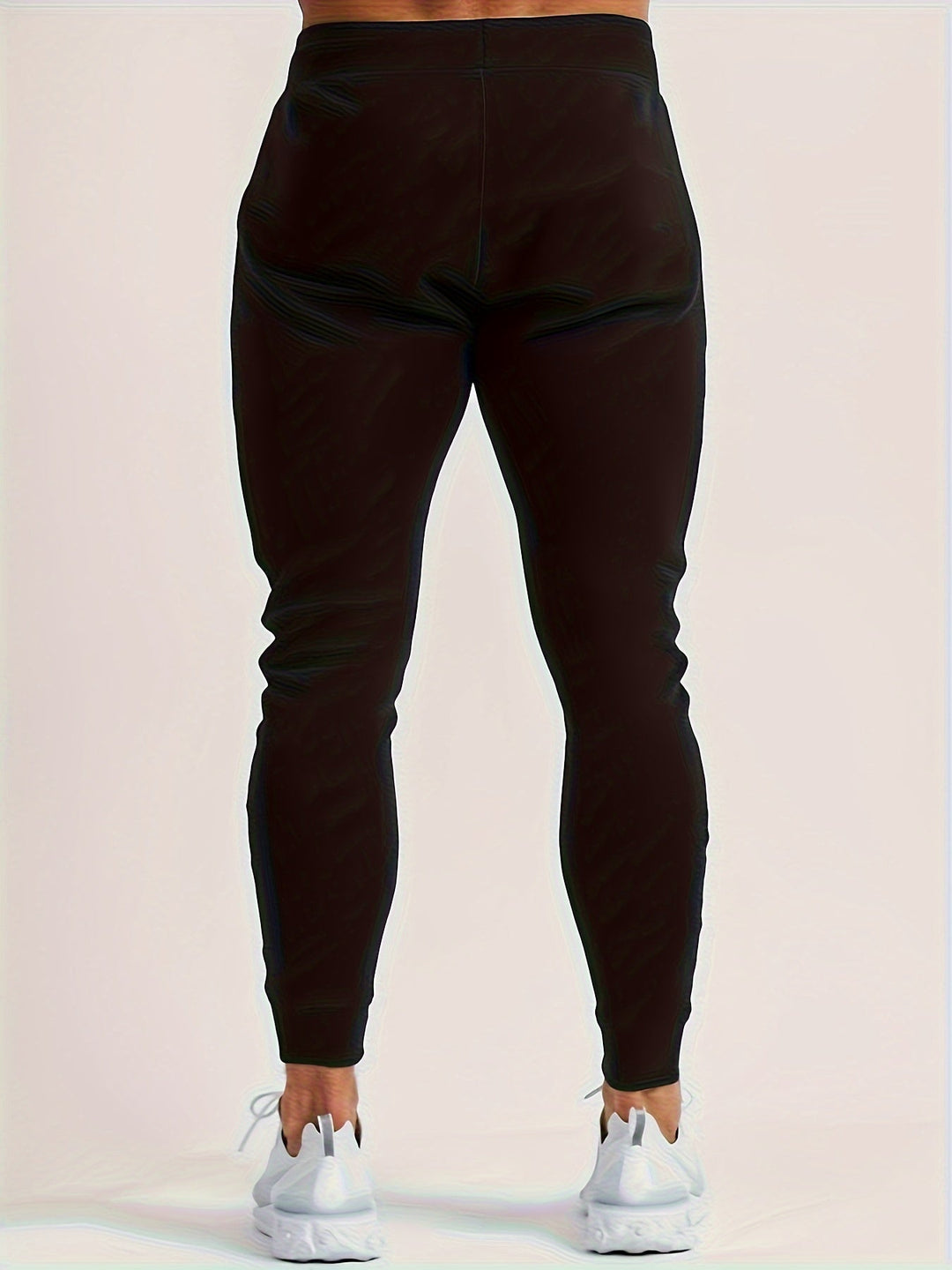 New black polyester joggers for men, slim fit design for performance and casual comfort.