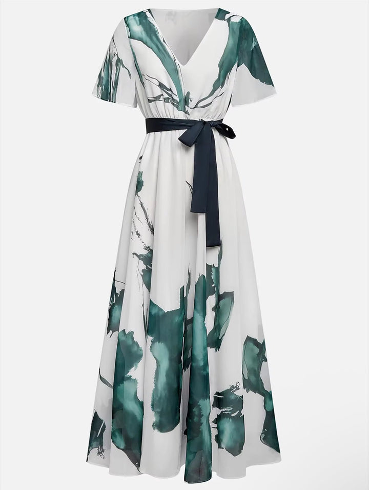 Full view of a woman wearing an elegant, flowing watercolor print long dress, suitable for any summer occasion.