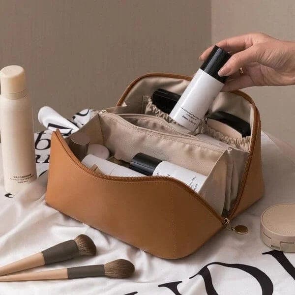Stylish portable leather cosmetic bag, open showing spacious interior for beauty accessories, new condition