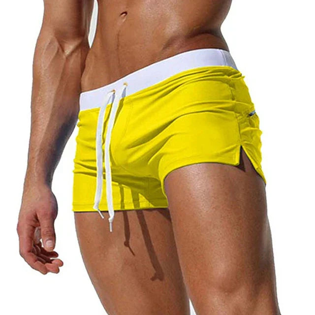 Athletic men's board shorts, quick-drying fabric, adjustable drawstring for swimming & beach activities.