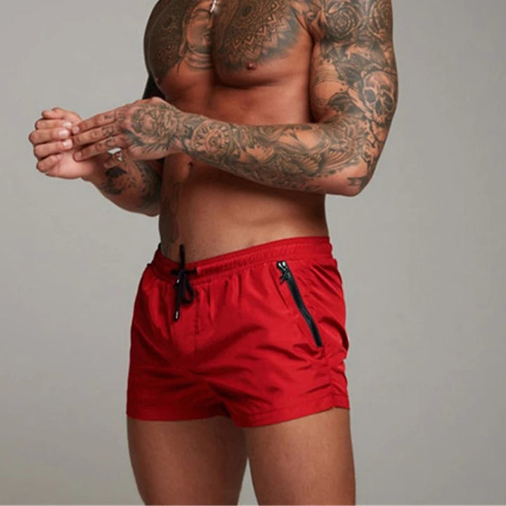 New men's swimwear: green quick-dry stretchy swim shorts on a white background, summer essential.
