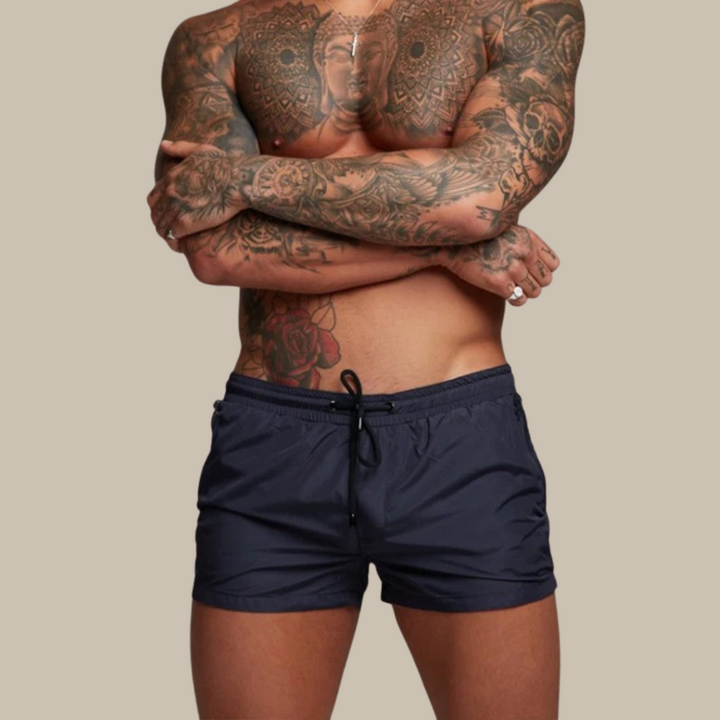 Comfortable men's quick-dry swim shorts, stretchy patterned design, perfect for beachwear & swimming.