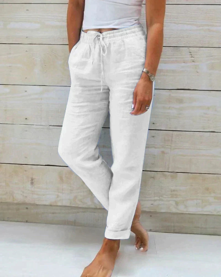 Relaxed fit women's linen trousers in natural color, offering comfortable summer wear