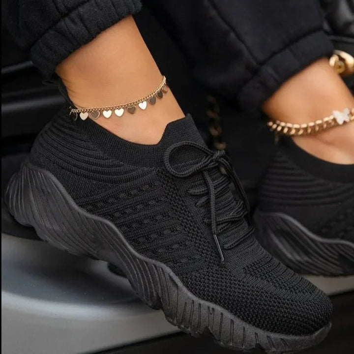 Closeup of women's new lightweight mesh sneakers, highlighting breathable design and comfort.
