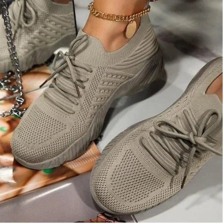 Detail shot of new women's mesh footwear, emphasizing lightweight and breathable sneaker construction.
