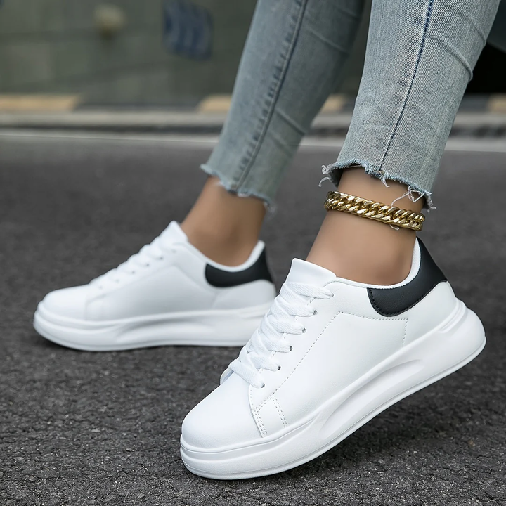Stylish women's white leather sneakers, providing orthopedic comfort for casual and everyday use.