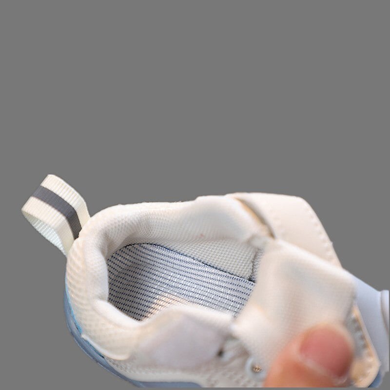 Close-up of flexible baby barefoot shoes, highlighting soft sole and slip-on design for infant comfort.