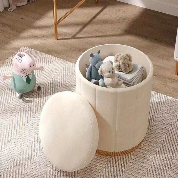 Modern round storage ottoman, ideal for living rooms. Features a chic mirror finish & fabric.