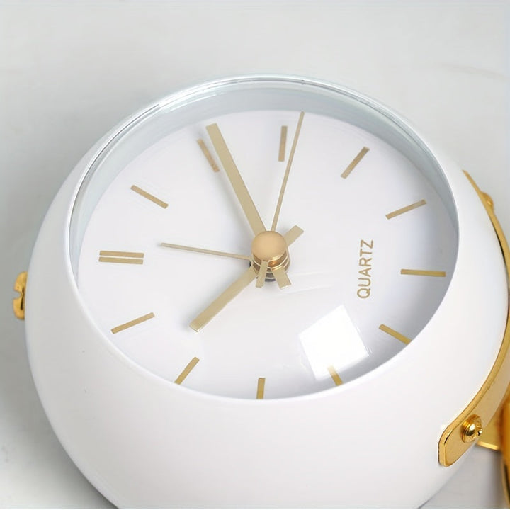 Contemporary silent desk clock with a sleek metal frame and luminous hands. Battery-operated timepiece.