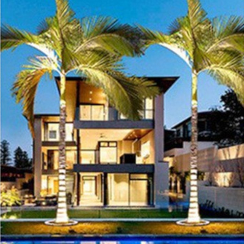 "Outdoor LED spotlights softly lighting tree bases with warm white glow, enhancing garden aesthetics with elegant aluminum de