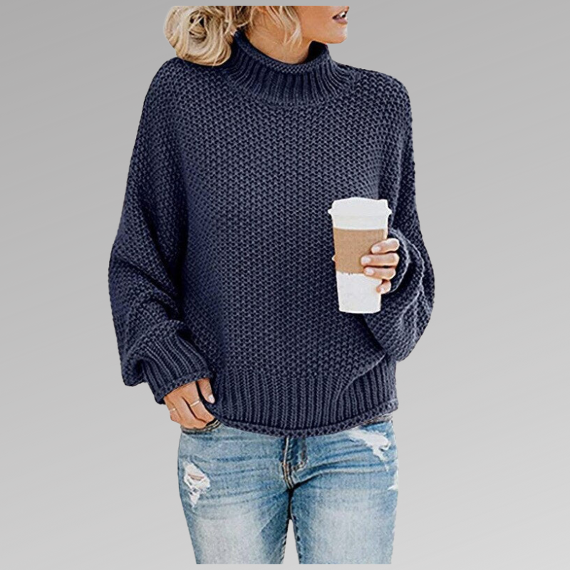 Close-up of the chunky knit texture on a women's oversized spring sweater