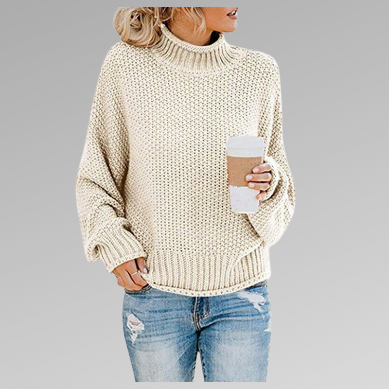 Woman wearing a light-colored oversized chunky knit sweater with jeans