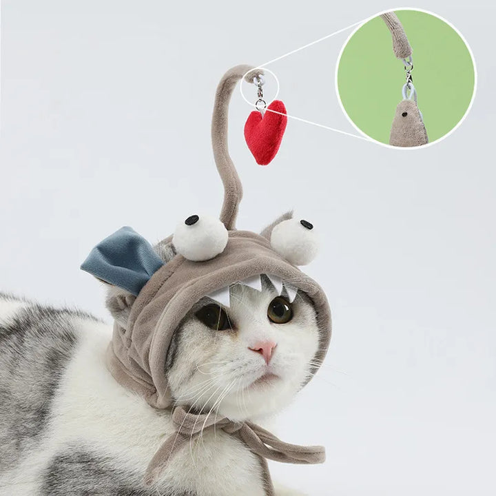 Cat playing with an interactive feather toy attached to a cute pet costume hat.