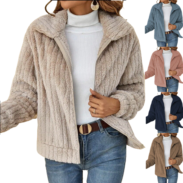 Detail of a women's sherpa fleece winter jacket pocket, highlighting practical features