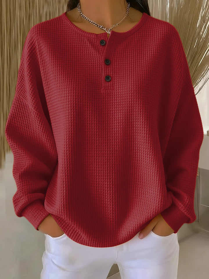 Womens apparel: Soft cream waffle knit Henley top with buttons, a versatile and cozy shirt.