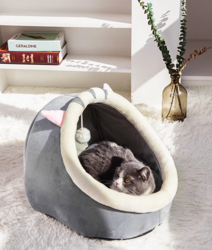 Plush cat igloo bed cave with playful ball, offering a cozy hideaway for feline comfort. Perfect pet bed.