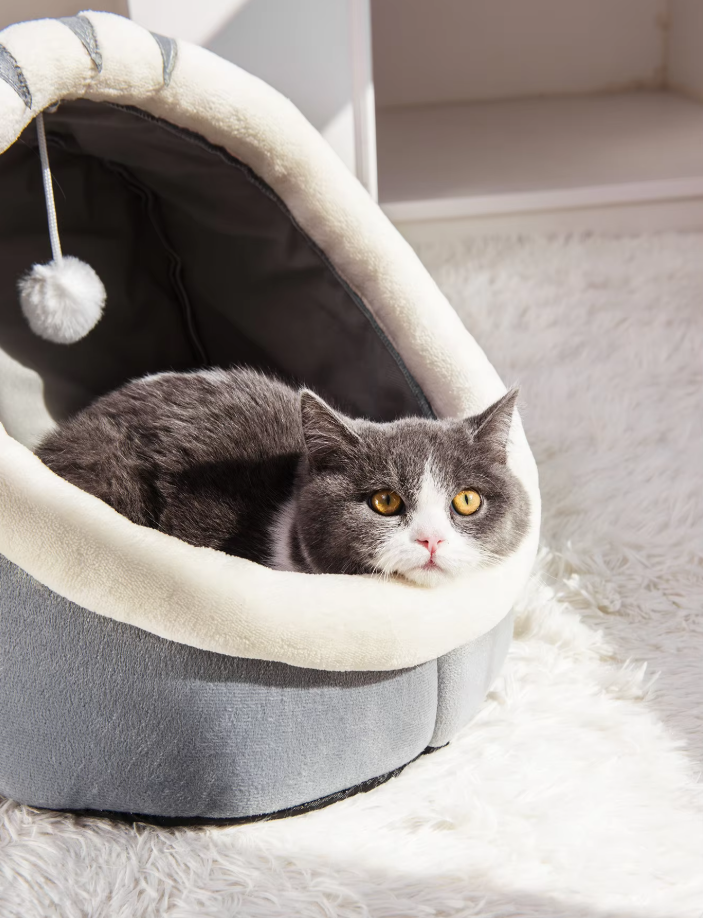 Cute cat igloo bed cave, a soft plush hideaway for cats. Includes a playful attached ball for entertainment.