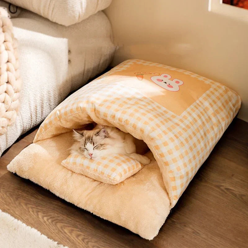 Adorable cat enjoying a deep nap in a warm, plush sleeping bag pet bed. Super cozy feline comfort.