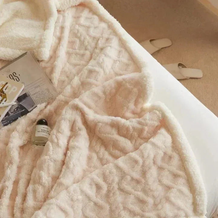 Elegant plush wool throw blanket, a heavy knit design that adds sophisticated warmth to any room.