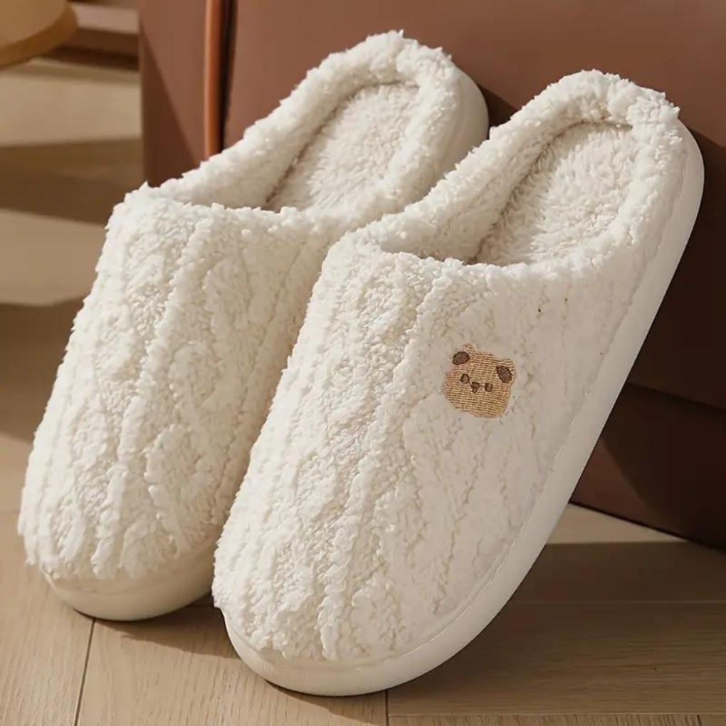 Plush pink women's spring slippers, soft and cozy for indoor comfort, with a cushioned sole.