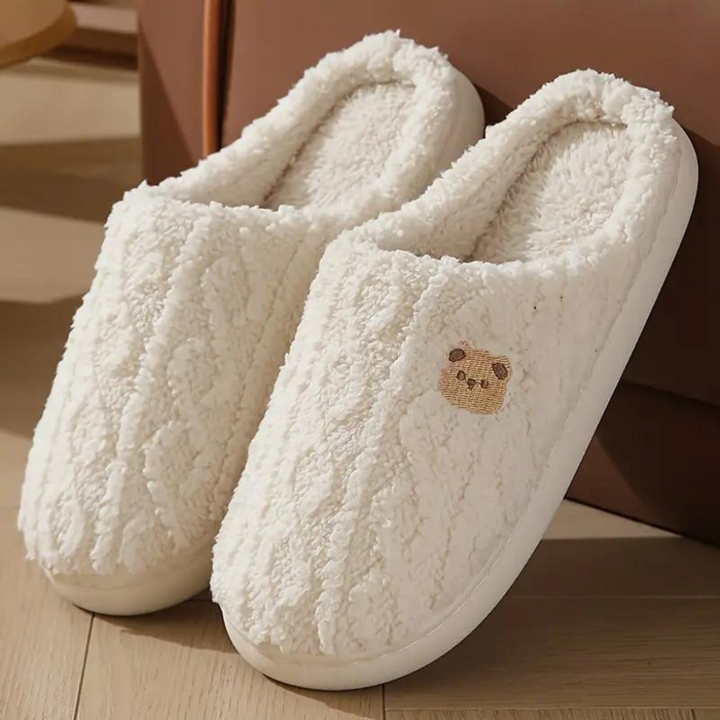 Plush pink women's spring slippers, soft and cozy for indoor comfort, with a cushioned sole.