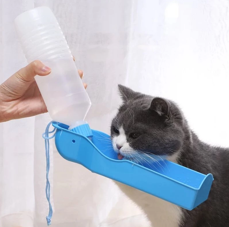 Portable dog water bottle with integrated pet bowl, perfect for travel and walks.