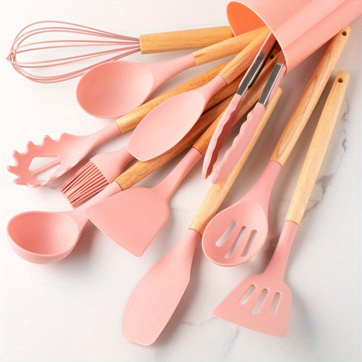 Complete silicone cooking tools set: whisk, spatula, tongs with wooden handles for versatile kitchen tasks.