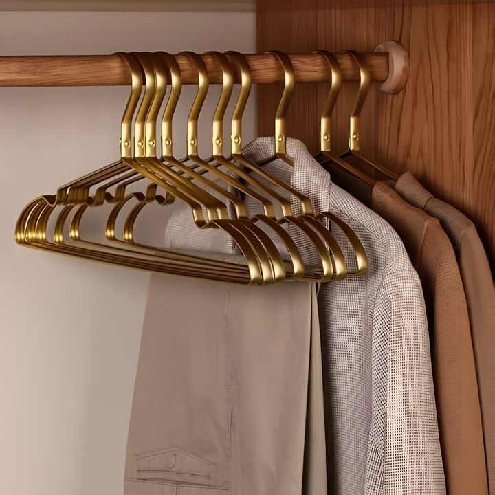 Durable anti-slip aluminum coat hangers in black or gold, ideal for space-saving wardrobe organization and garment care.