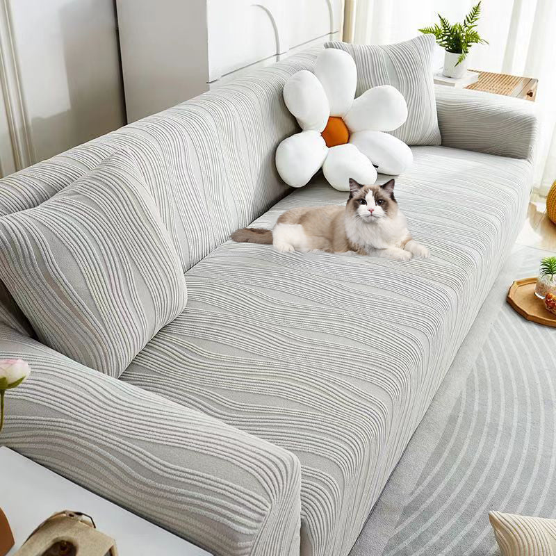 Full view of a living room with a premium jacquard stretch sofa cover, pet-friendly.