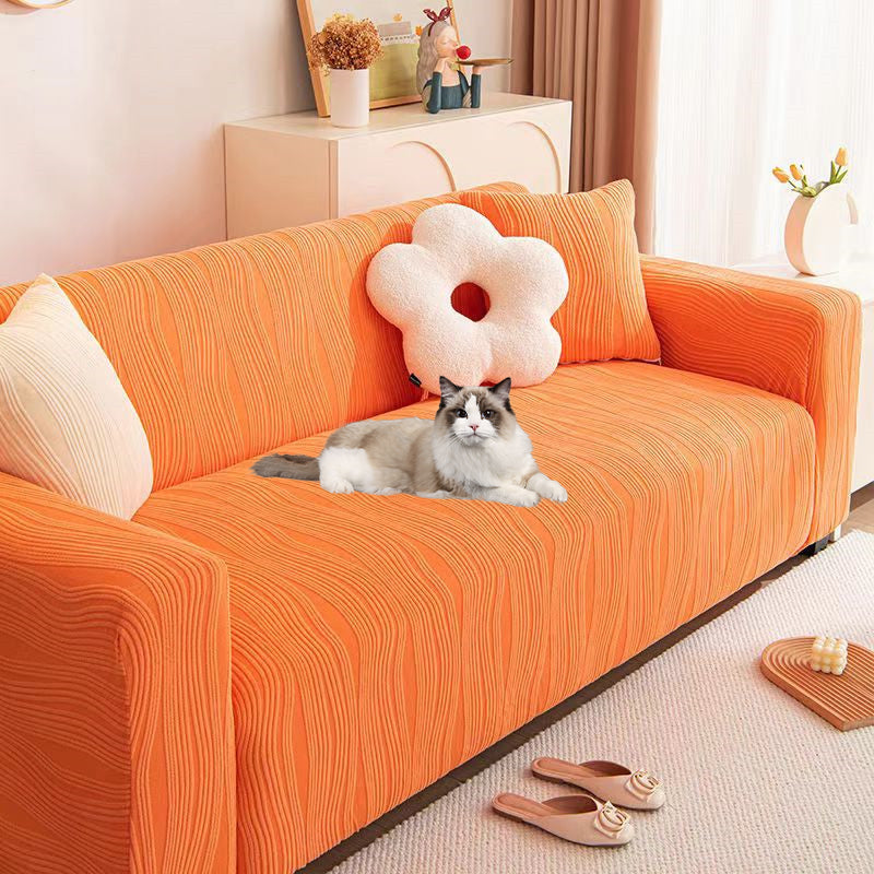 Textured jacquard sofa protector, pet-friendly, stretch fit, enhances home decor.