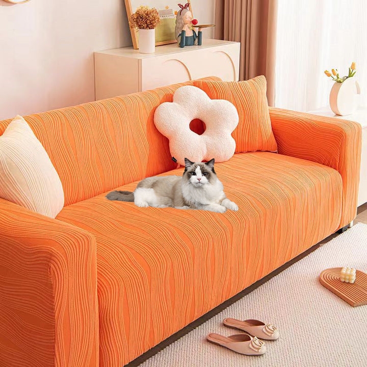 Textured jacquard sofa protector, pet-friendly, stretch fit, enhances home decor.