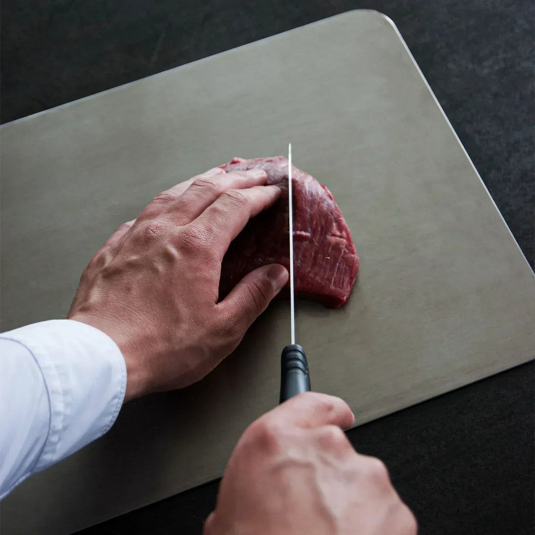 Easy clean, non-toxic titanium cutting board; essential for hygienic food prep in any kitchen.