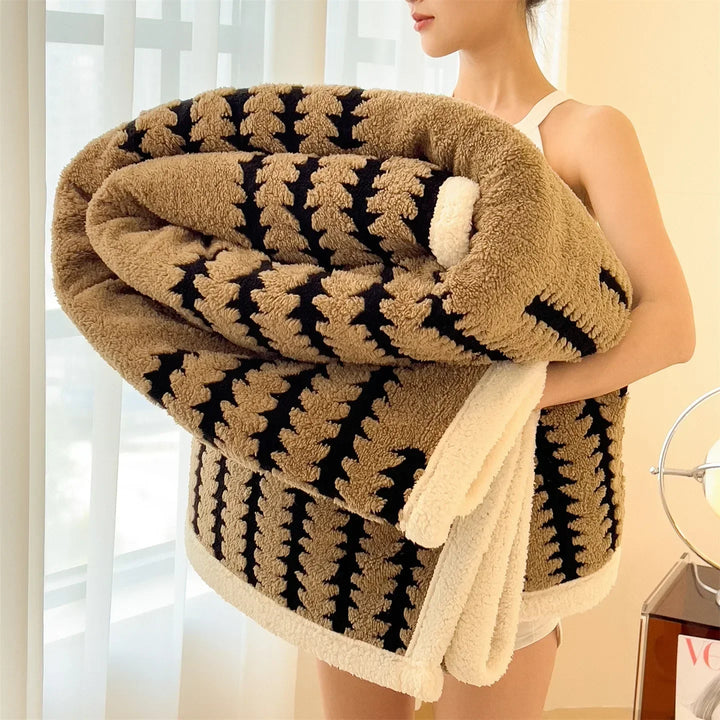 Decorative geometric pattern throw blanket, reversible with plush sherpa. Stylish home accent.