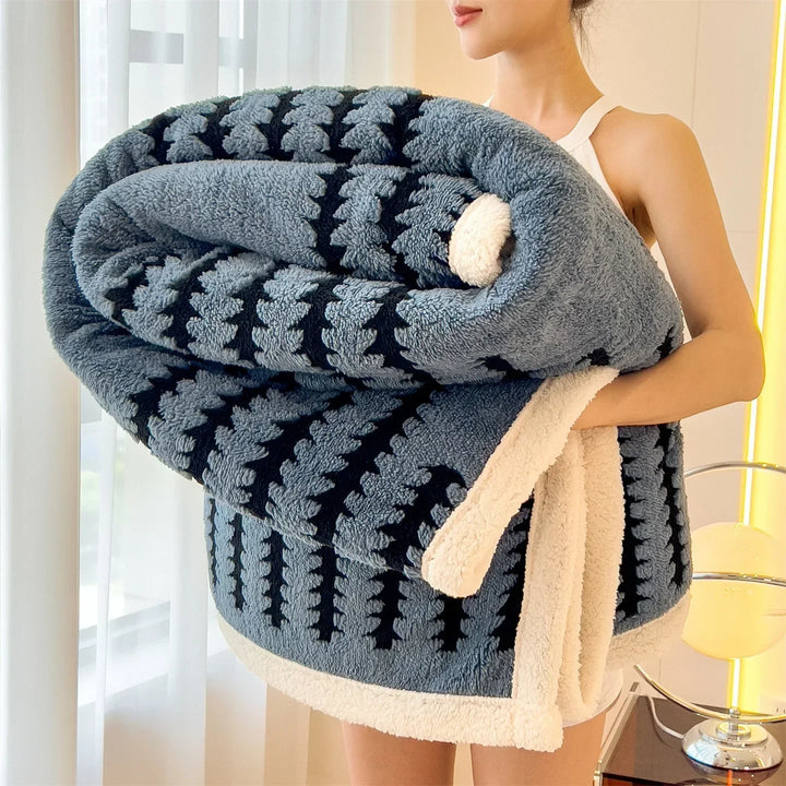 Cozy reversible throw blanket featuring a geometric design & warm sherpa fleece for comfort.