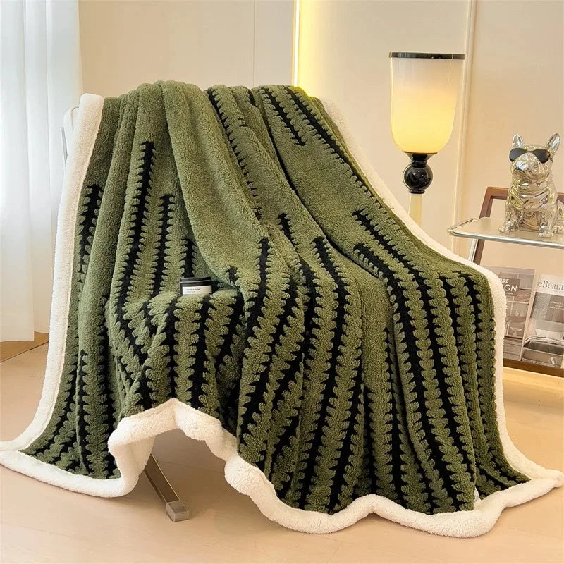 Reversible throw blanket with intricate geometric pattern & plush sherpa fleece. Soft, warm living room decor.