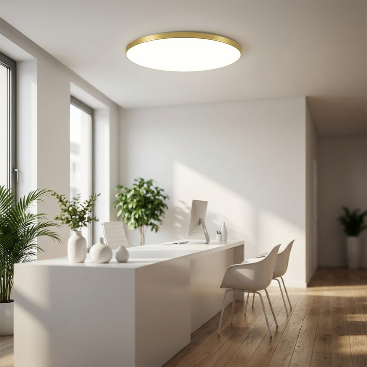 Sleek round LED ceiling light with gold accent, slim modern design for beautiful interior lighting.