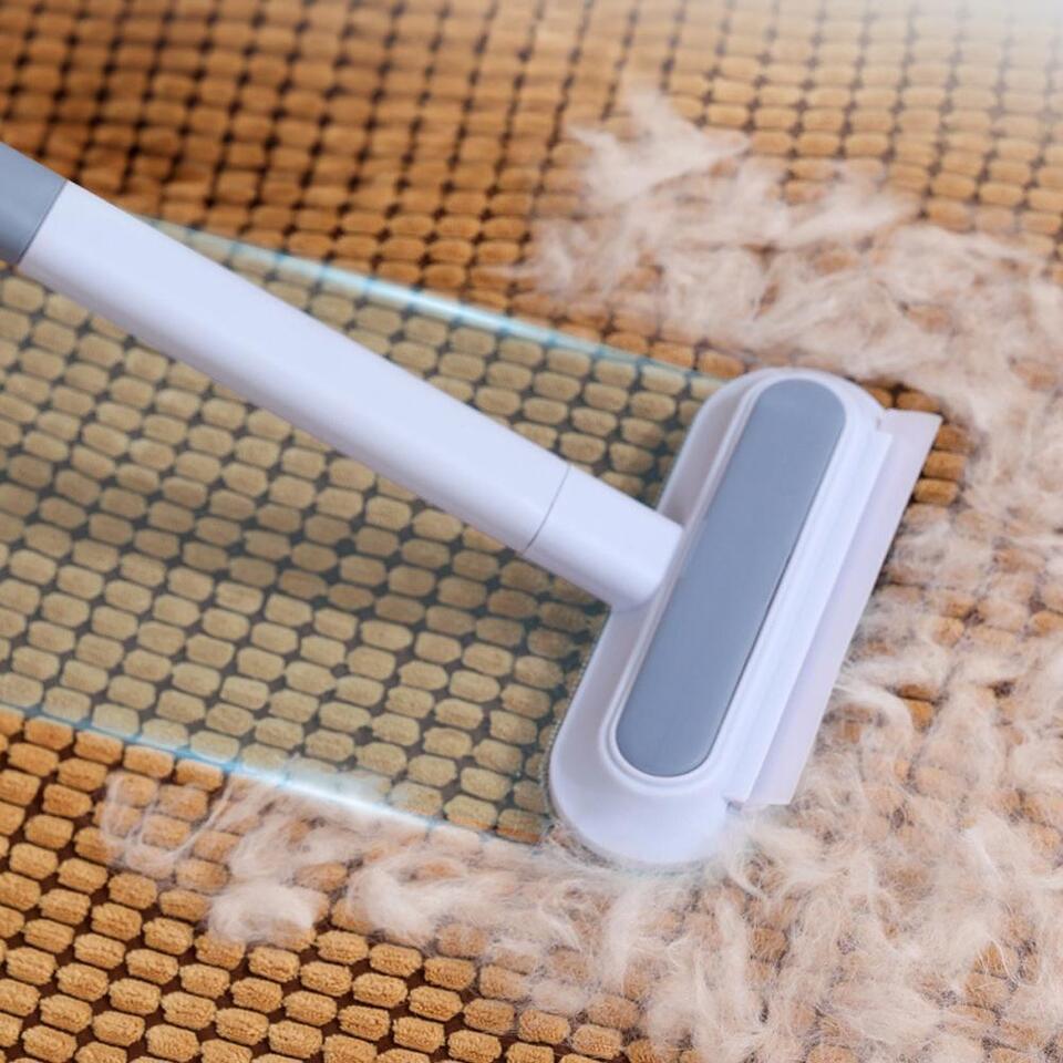 Handheld pet hair remover for effective cat & dog fur cleaning on clothes, beds & fabric.