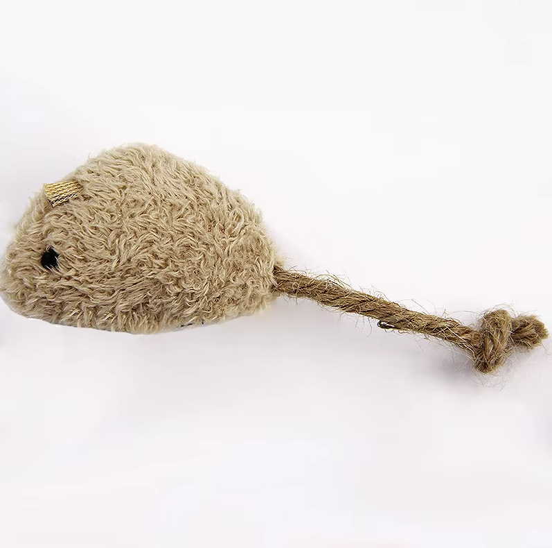 Close-up of a cat pouncing on a soft plush mouse toy, encouraging natural hunting instincts.