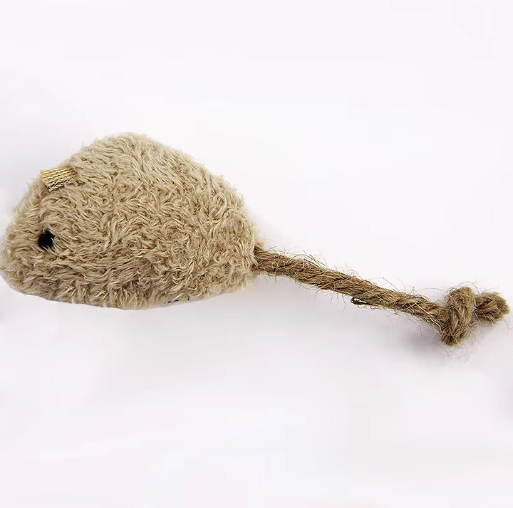 Close-up of a cat pouncing on a soft plush mouse toy, encouraging natural hunting instincts.