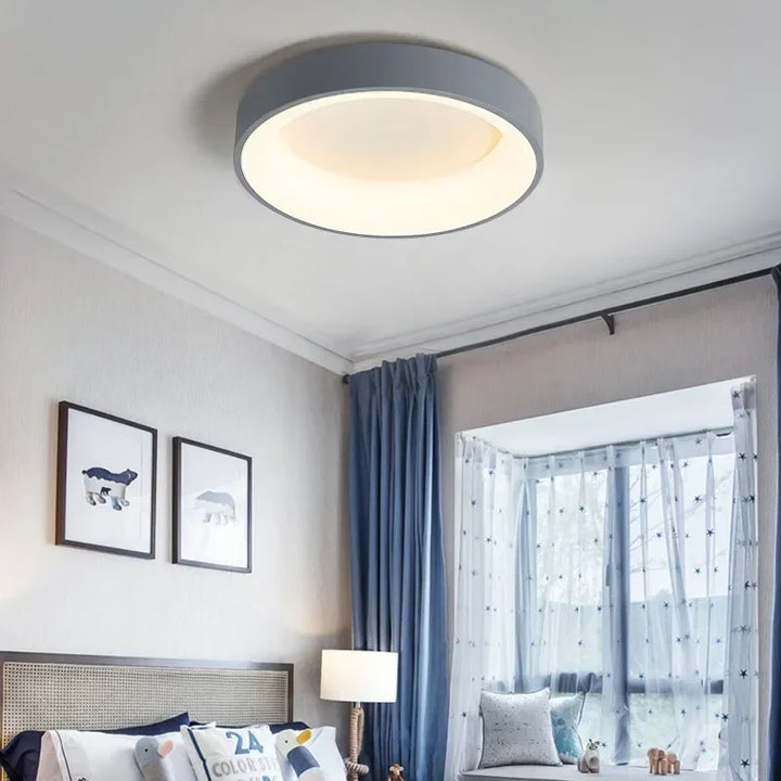 Minimalist round LED ceiling light. Modern Nordic style, ideal for sleek bedroom or living room lighting.