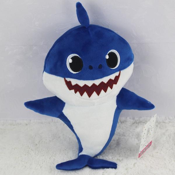 Cute singing Baby Shark plush toy, a soft interactive stuffed animal for kids' playtime fun.