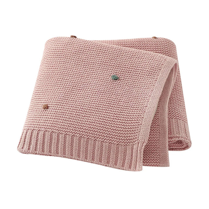 Soft cotton knitted baby blanket in a neutral shade, perfect for cozy infant comfort & nursery decor. A thoughtful newborn gift.