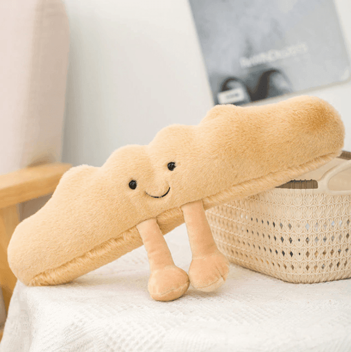 Soft, fluffy croissant plush toy, perfect as a huggable stuffed animal for kids or a cute decorative pillow.