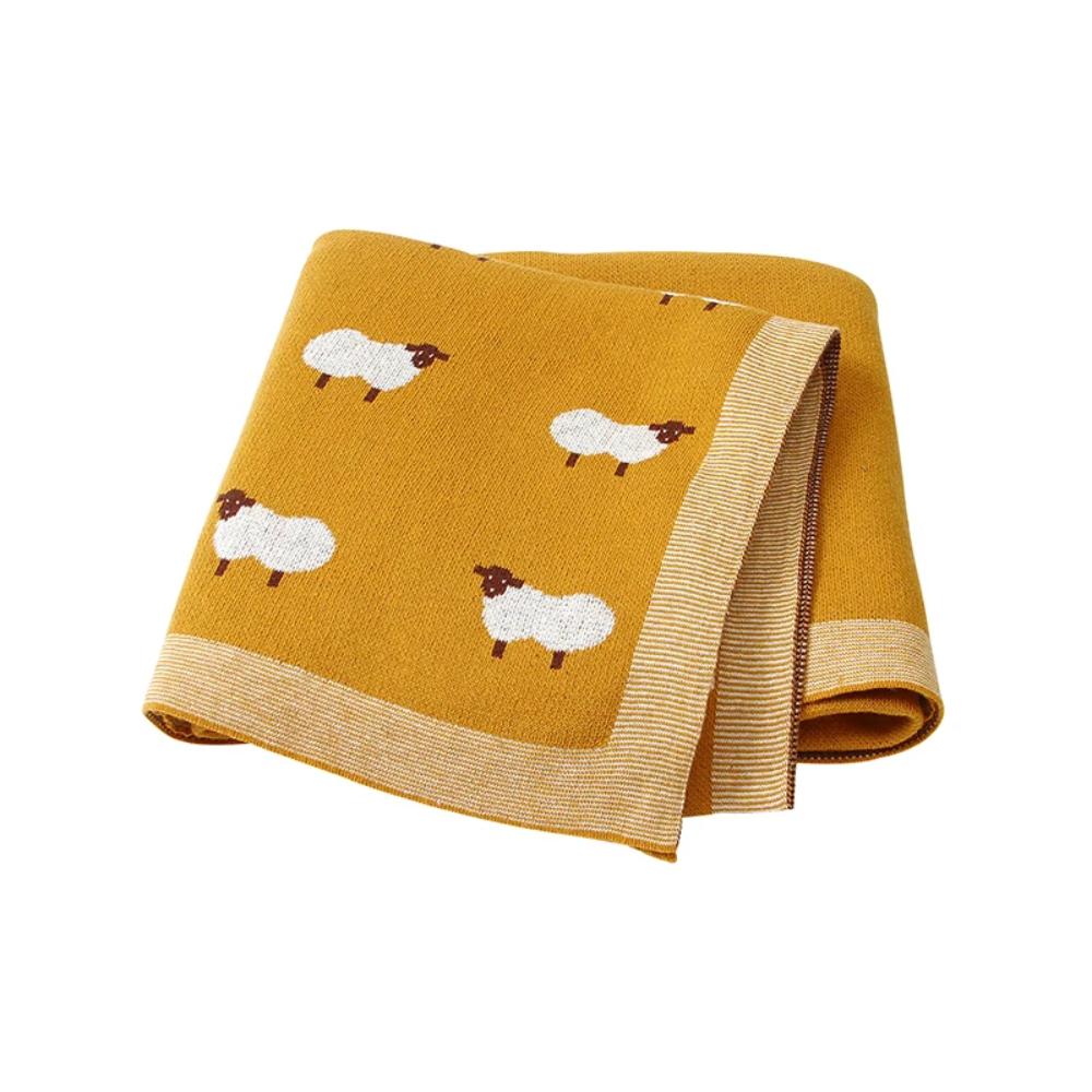 Newborn baby comfortably swaddled in a soft knit cotton blanket, providing cozy infant comfort.