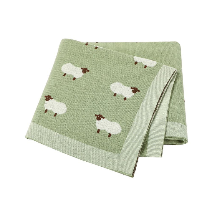 Unisex soft knit cotton baby blanket, folded neatly in a nursery, perfect as a cozy infant gift.