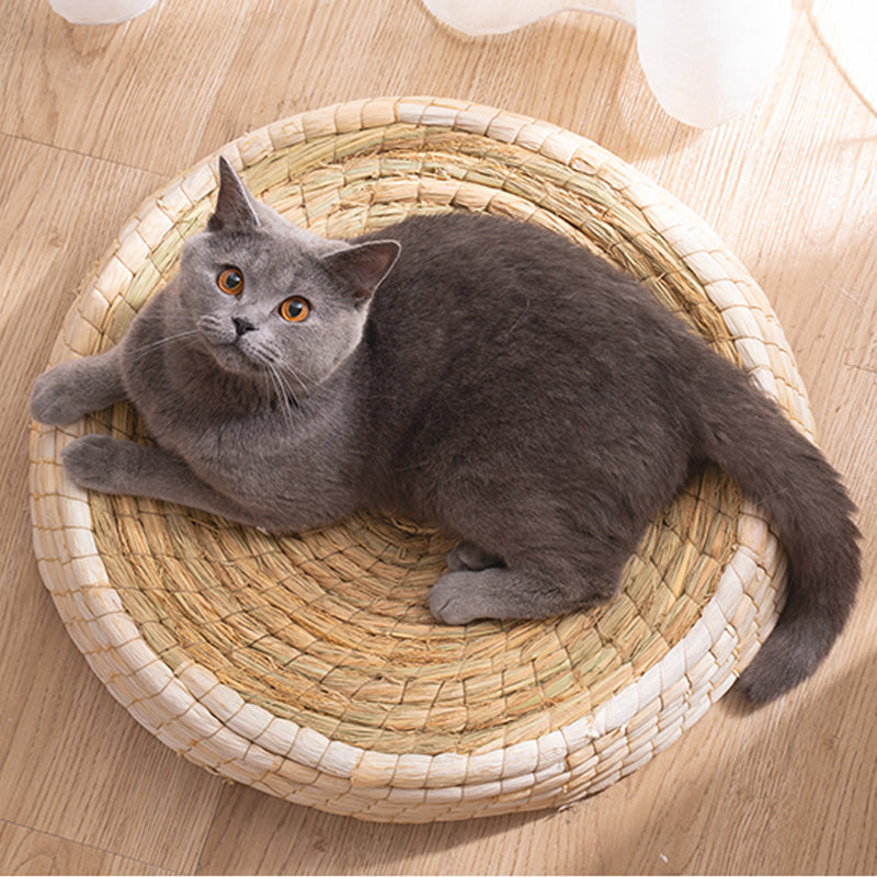Soft, round cat bed made from natural, eco-friendly materials, providing a cozy nest for feline comfort & secure sleep.