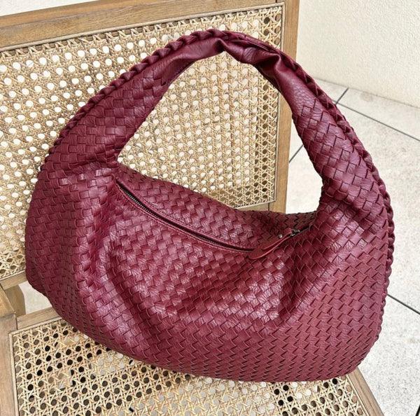 Elegant women's woven shoulder bag, crafted from soft vegan leather, perfect for everyday style.